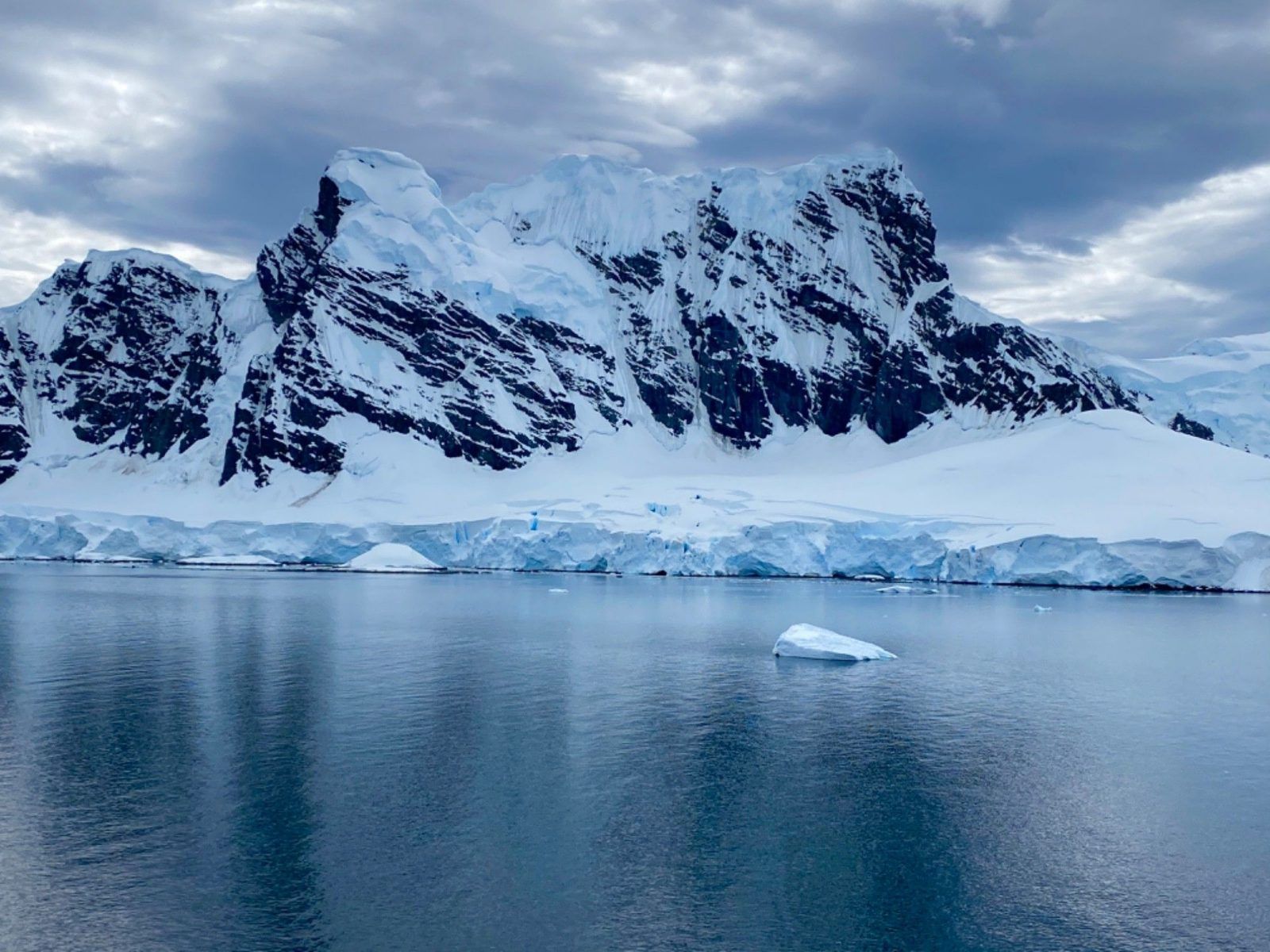 Dark rock ridges above a calm bay