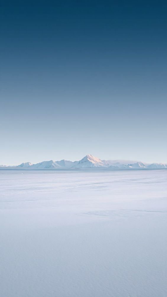 Flat white horizon under deep blue sky