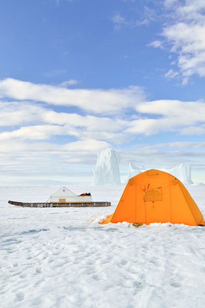 Orange tent on bright snow