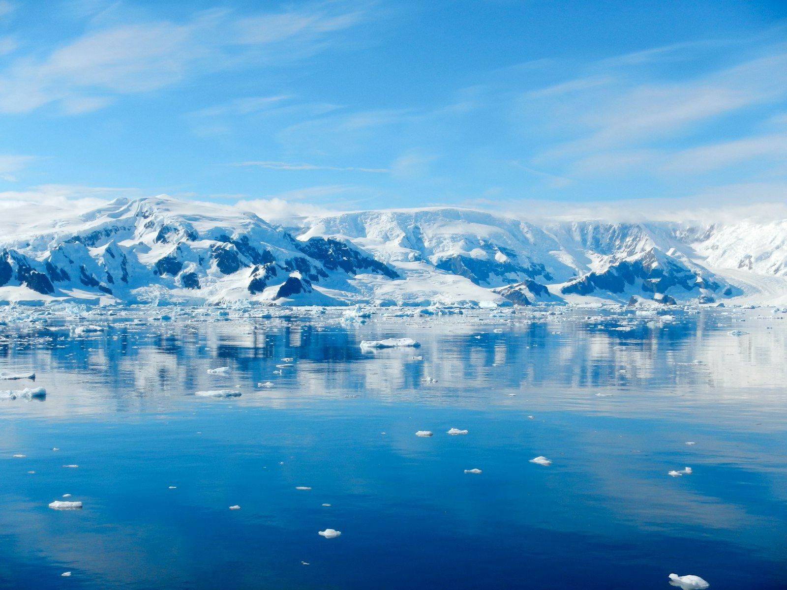 Mountains reflected in a still polar bay