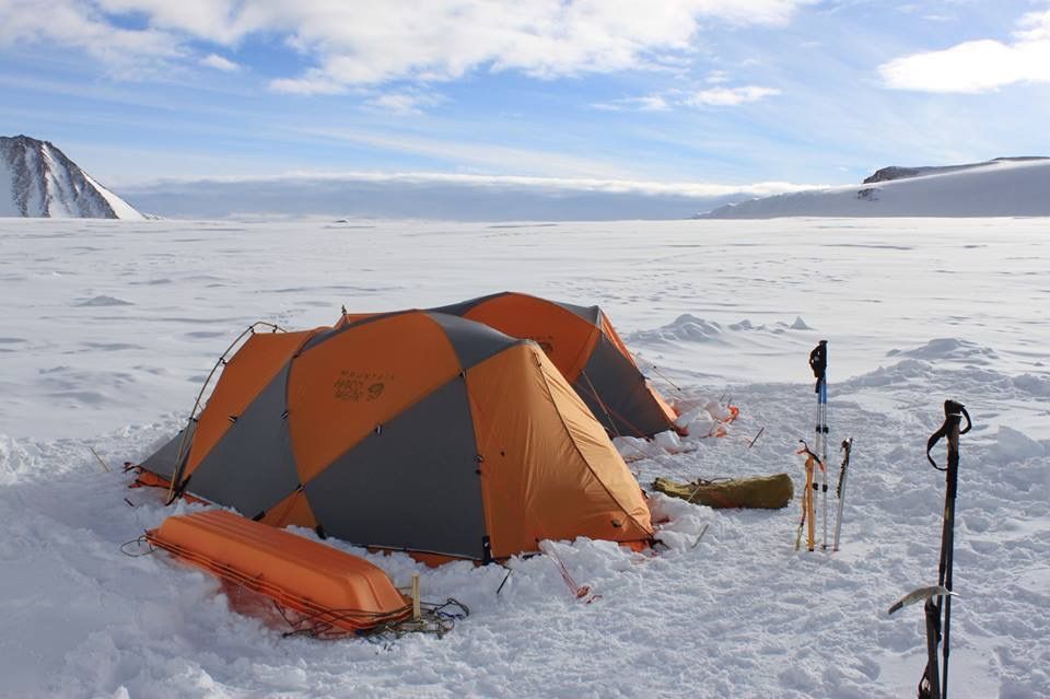 Tents and ski poles on a snowfield