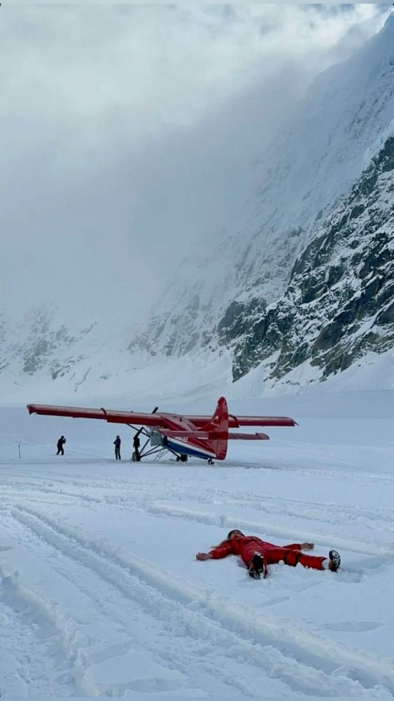 Two red planes on a snow runway