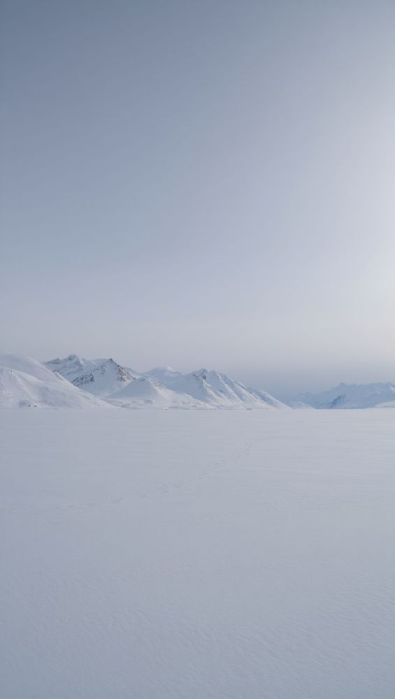 Pale horizon with distant peaks