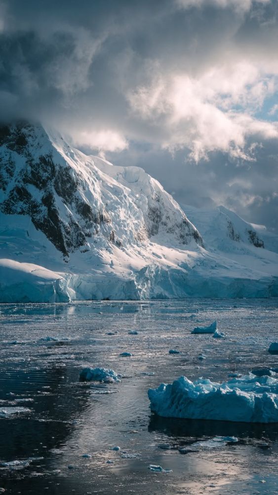 Rock and glacier over calm water