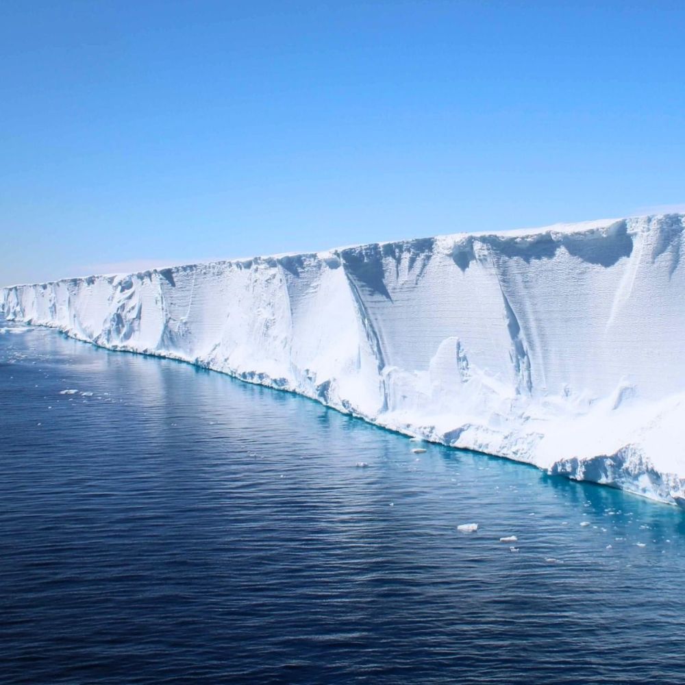 Long ice shelf cliff over the sea