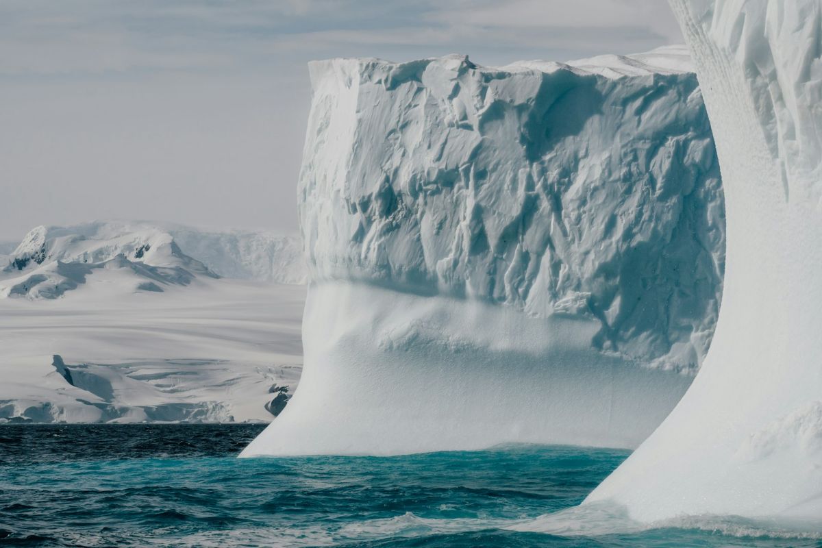 Ice arch over green water