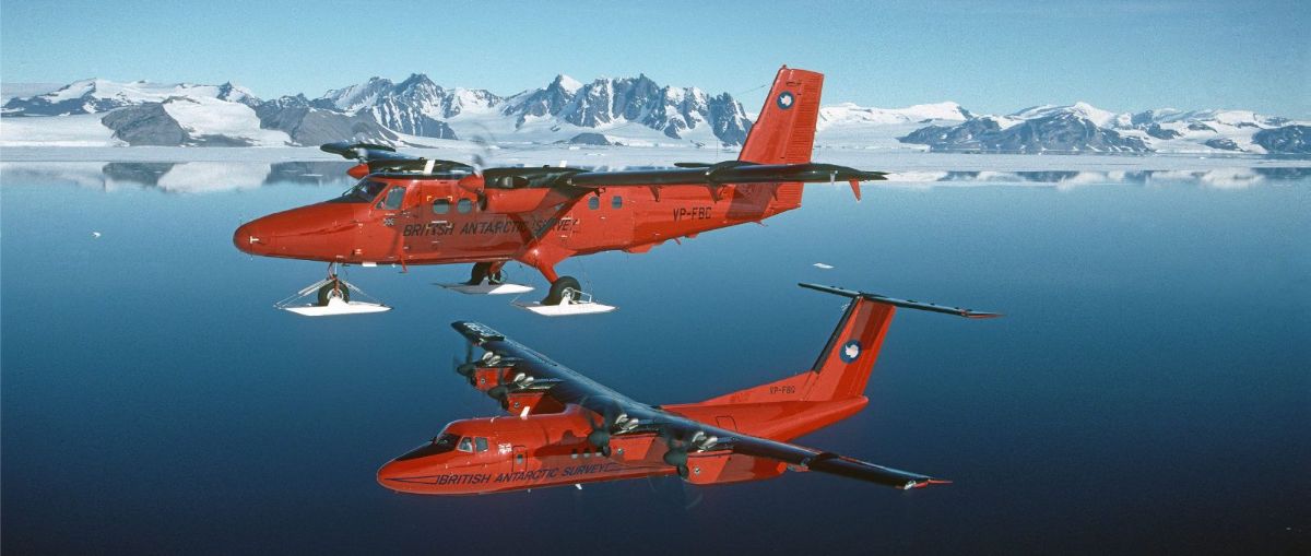 Two red ski planes over a polar bay
