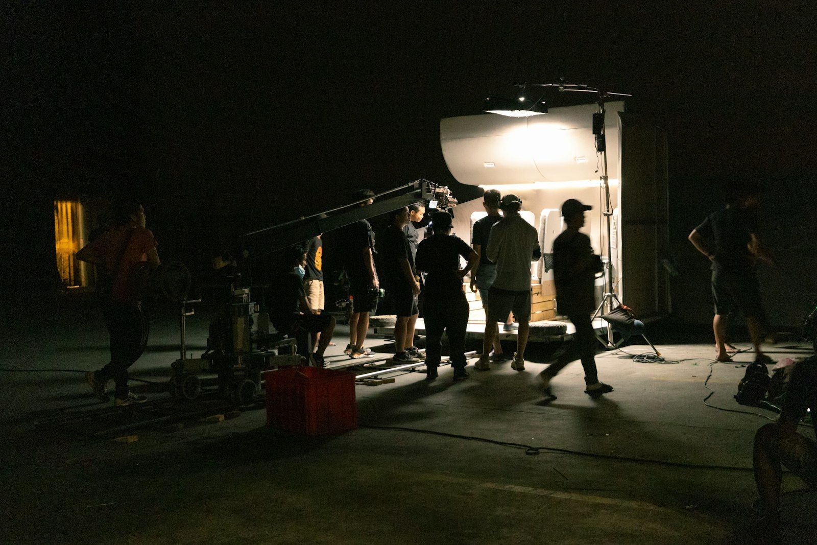 Night exterior with crew under a large light