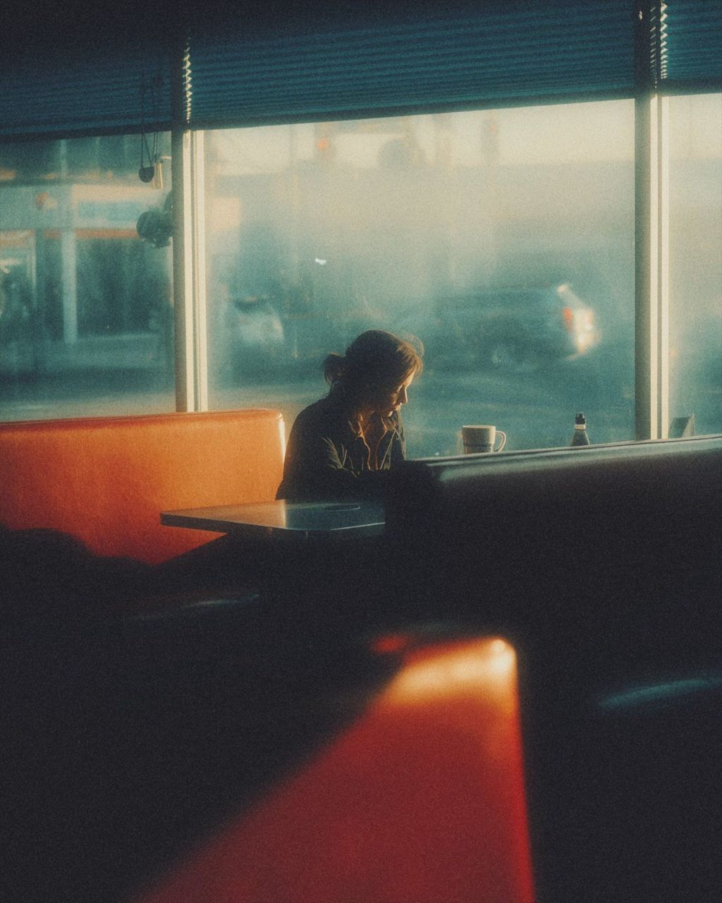 A diner booth in low sun
