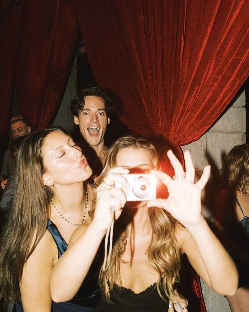 Friends taking a flash photo at a party