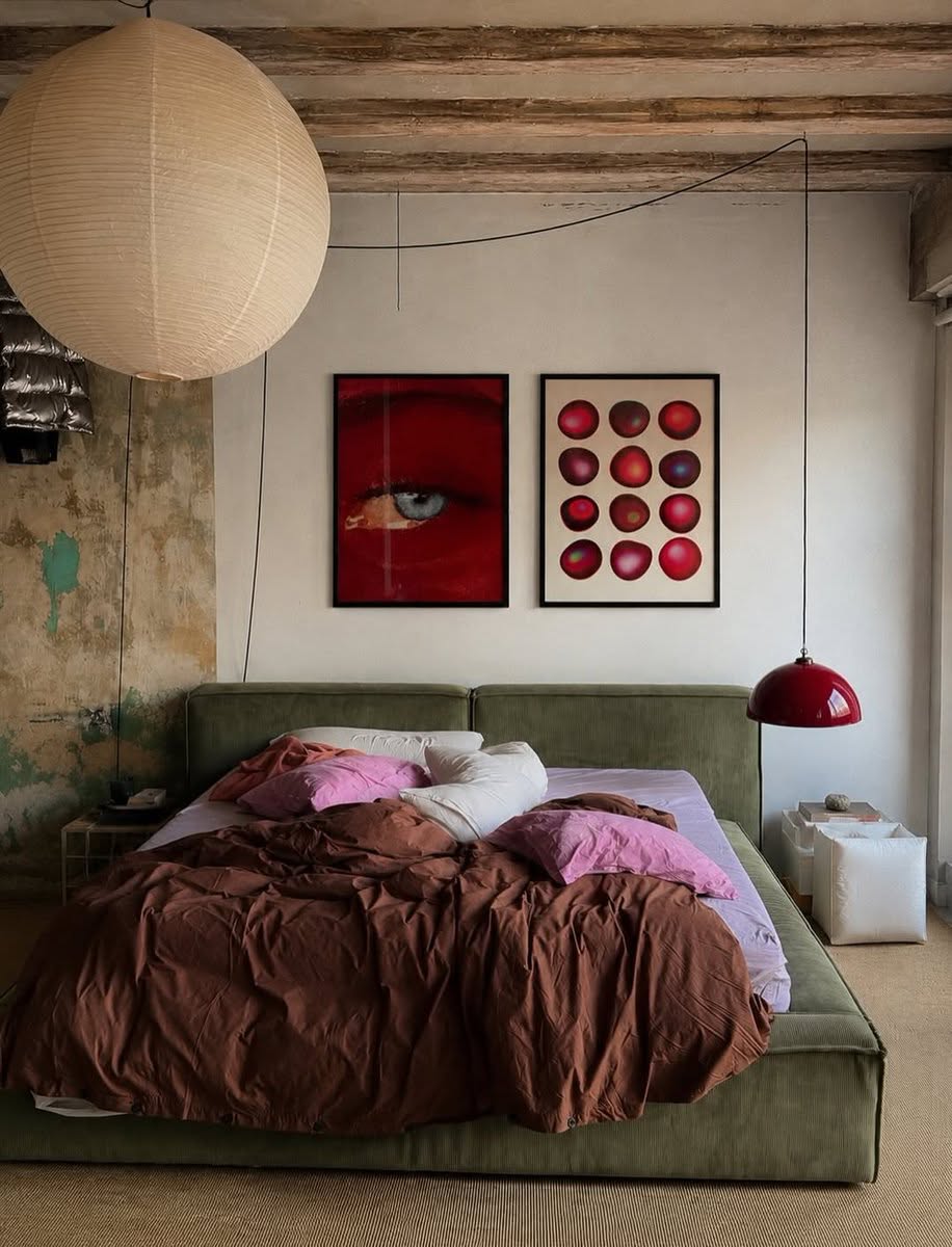 Bedroom with a paper lantern and rust bedding