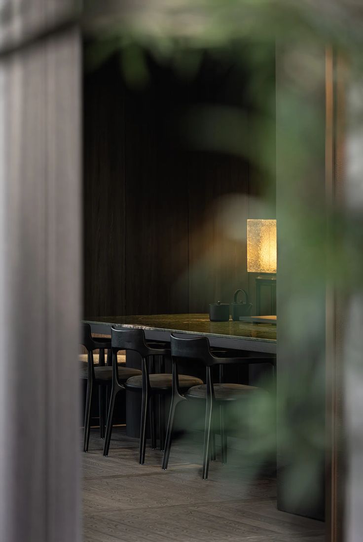Dark dining room seen through a doorway