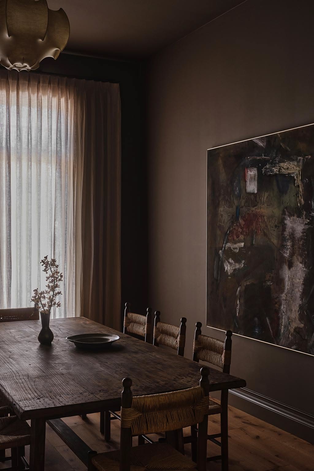 Dim dining room with a large dark canvas
