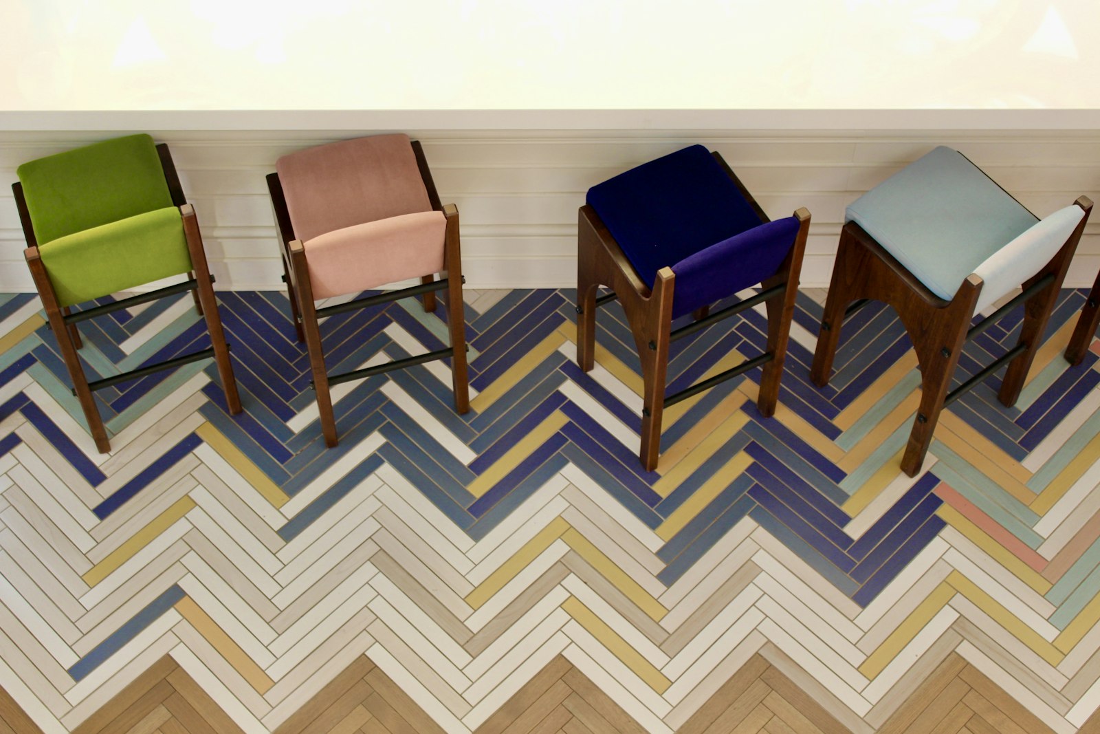 Two chairs on a chevron tile floor