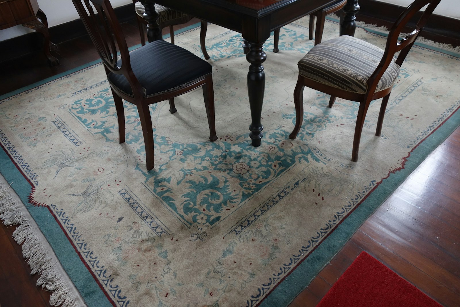 Dark chairs on a pale patterned rug