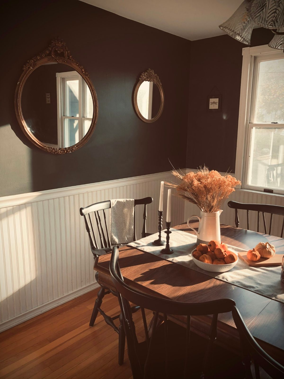 Breakfast table under round mirrors
