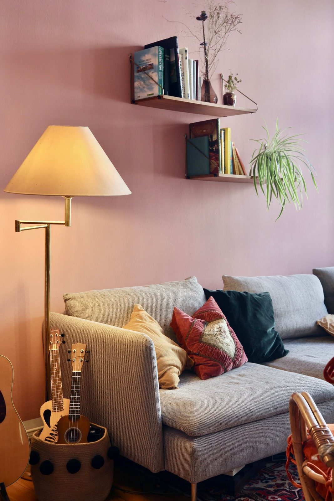 Pink-walled corner with a lamp and a patterned armchair