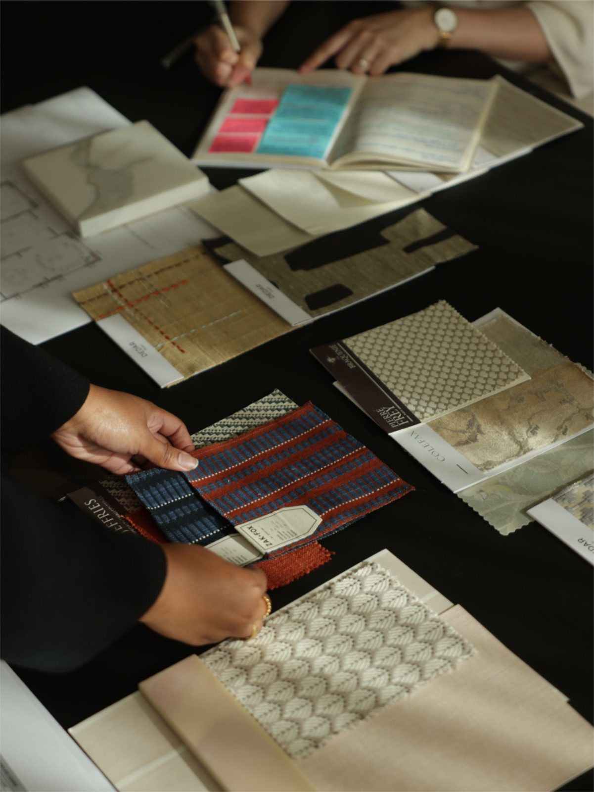 Designers laying out patterned fabrics