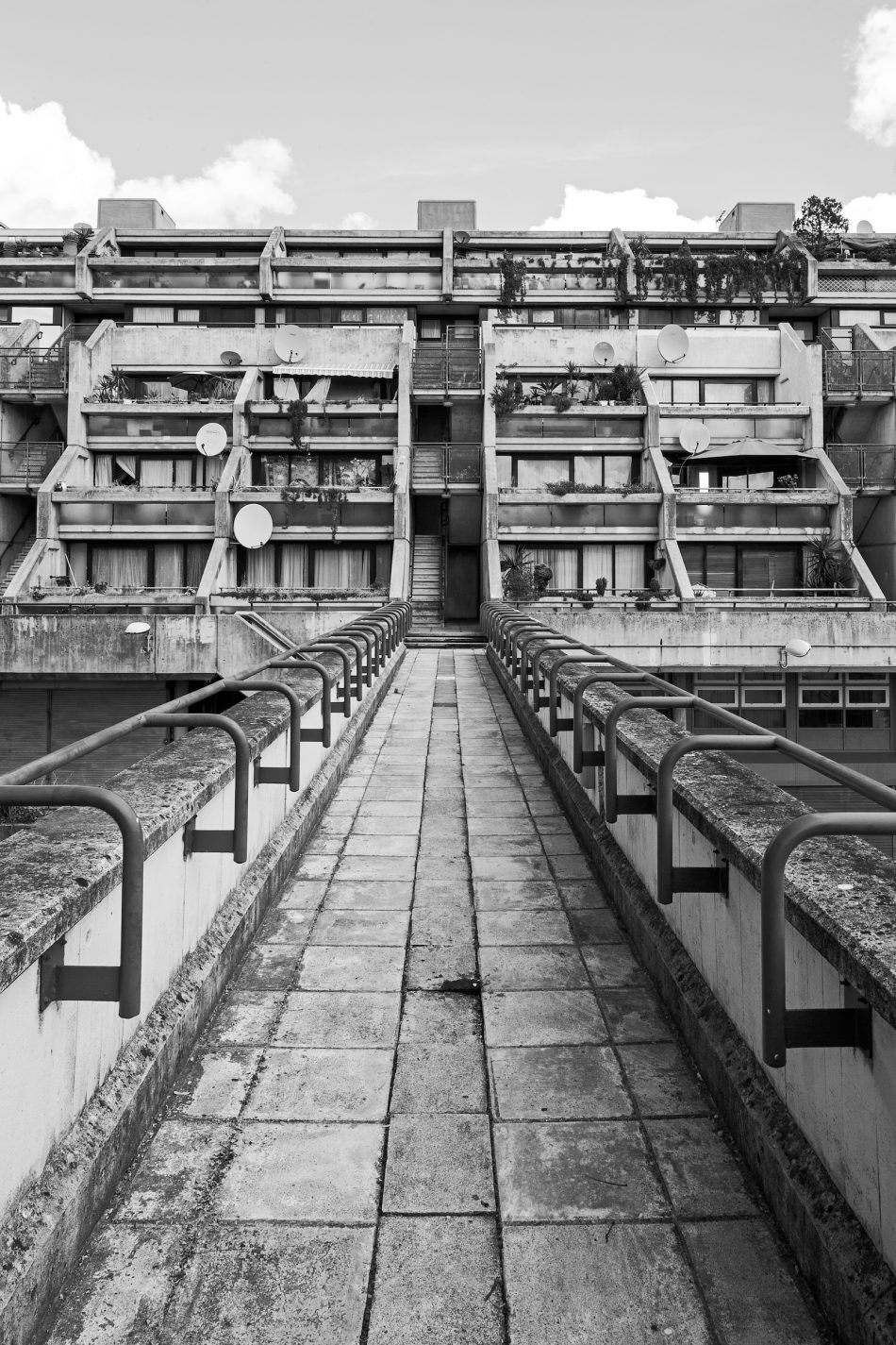Walkway toward a terraced concrete estate