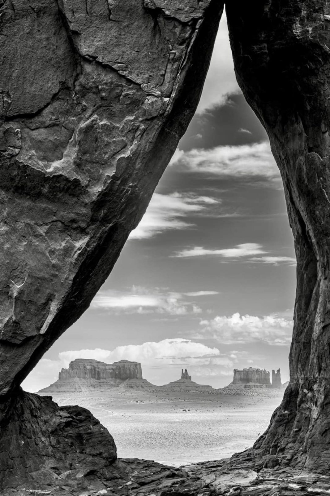 Desert buttes framed by a rock arch