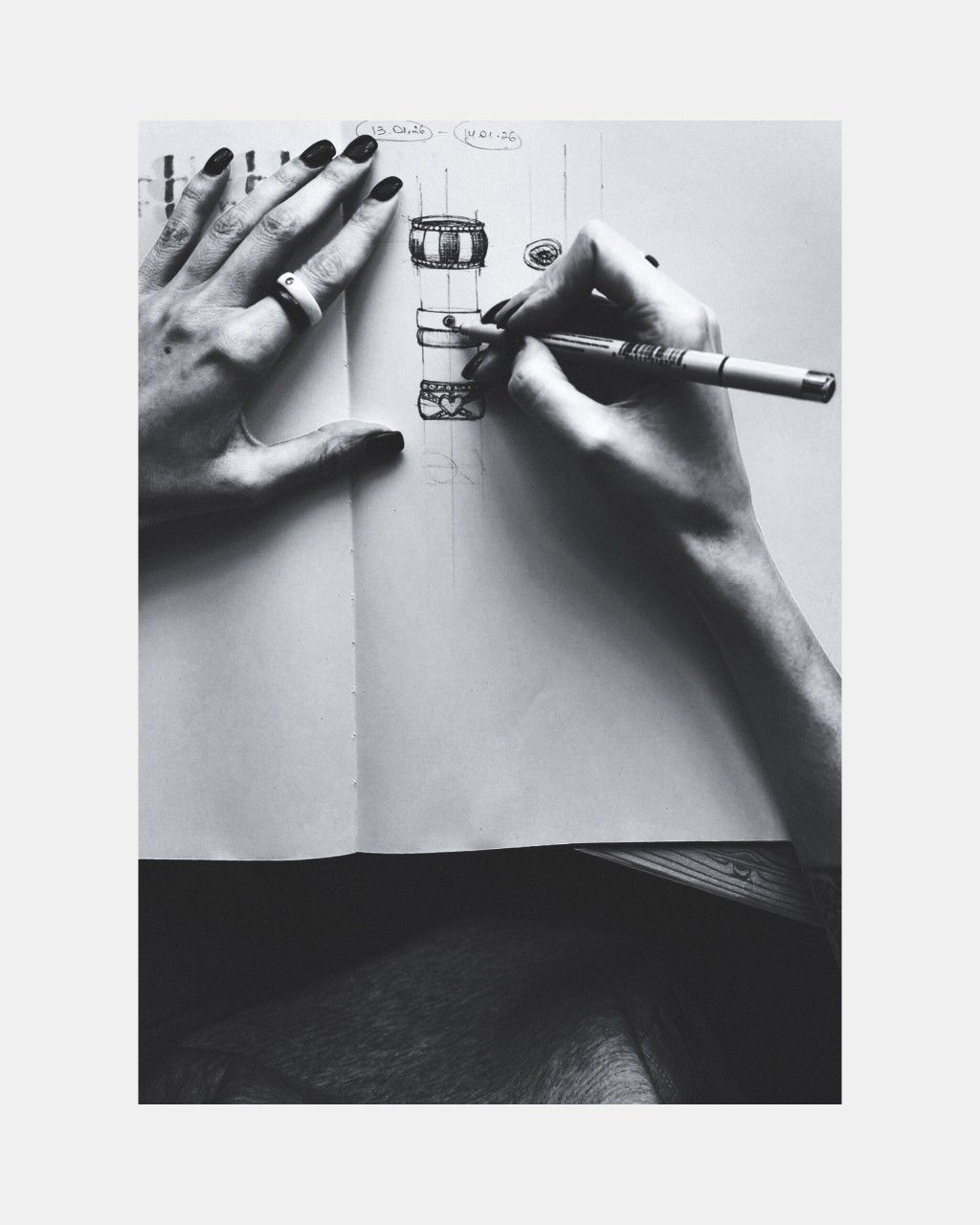 Hands and pen on a blank sheet