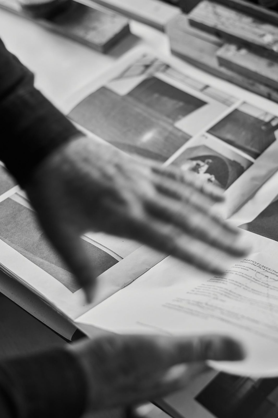 Hands over printed photographs