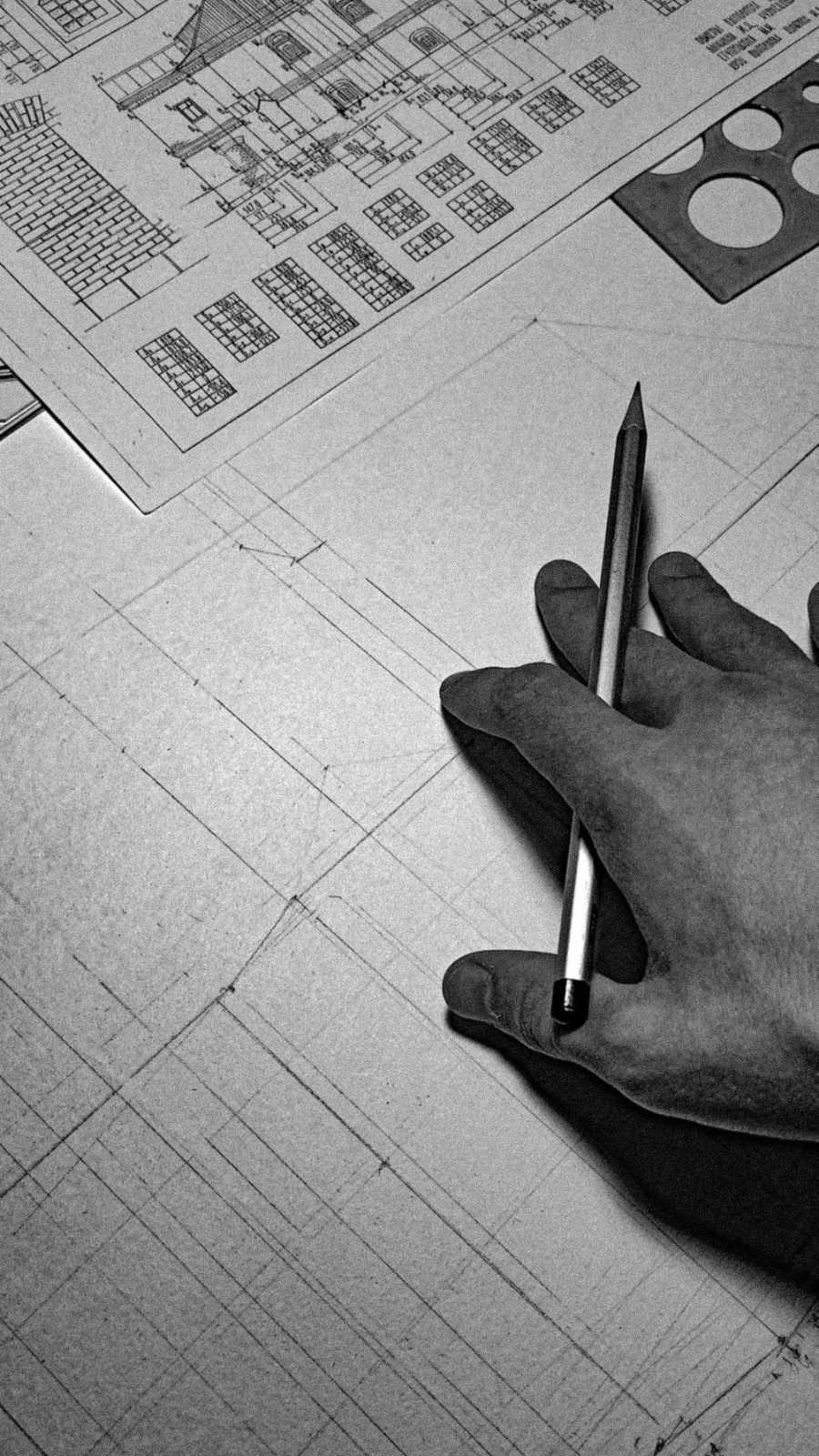 Pen held over a plan sheet