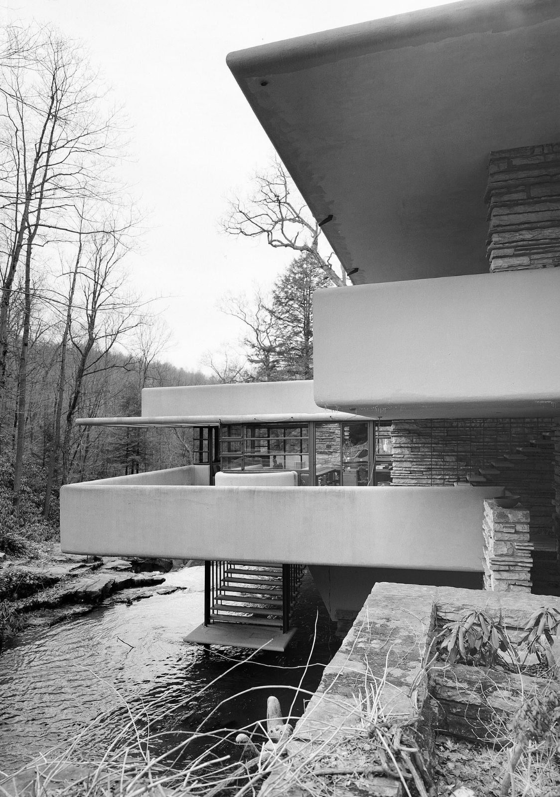 Stacked concrete terraces over a stream