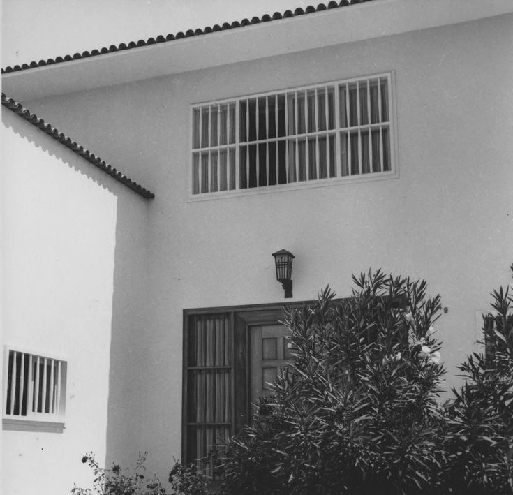 White wall, grilled window and lamp