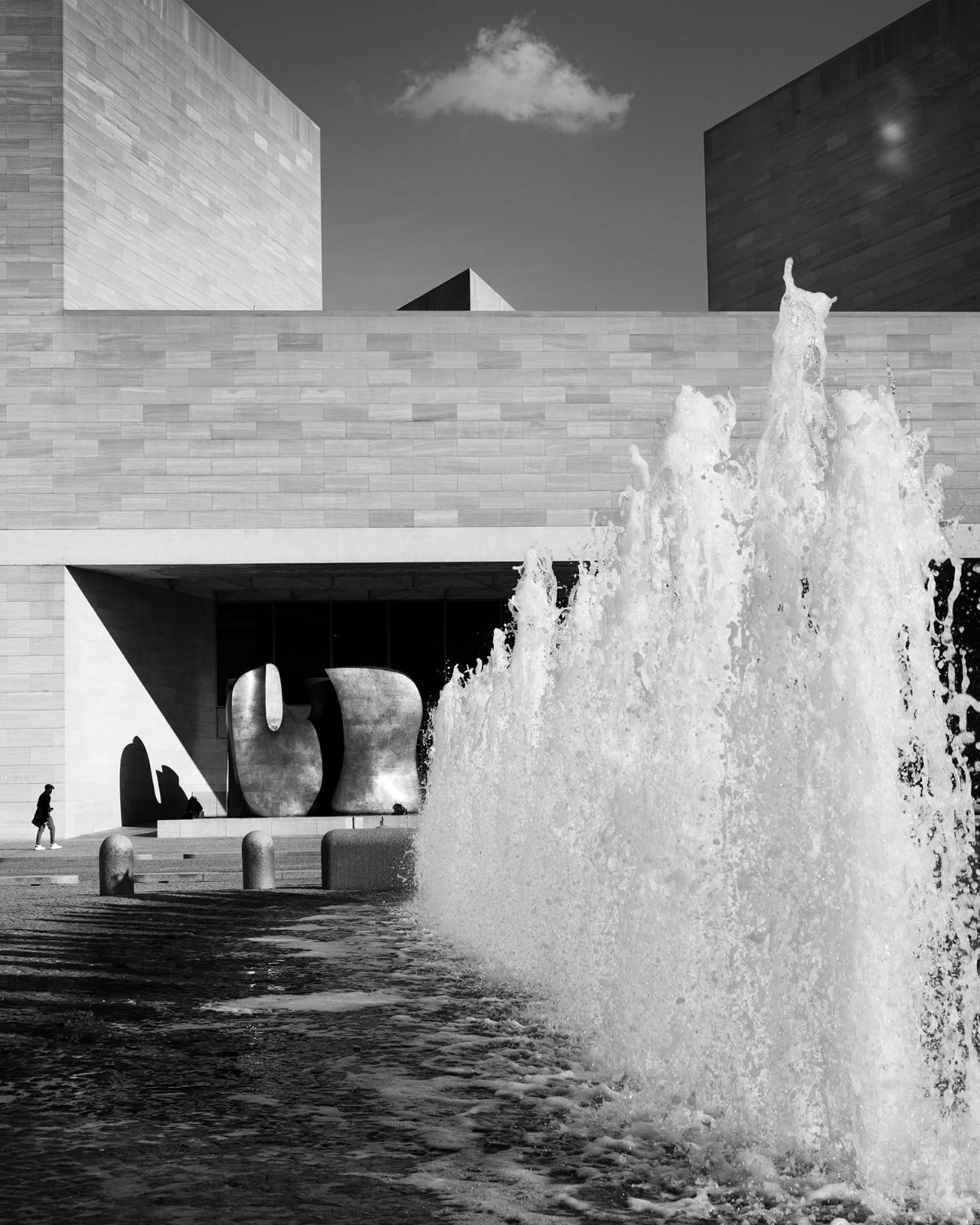 Fountain before a stone plaza building