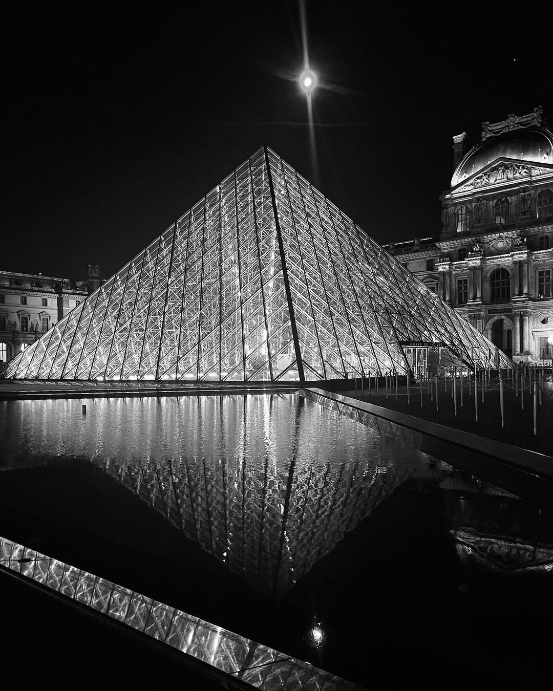 Louvre Pyramid and pools at night