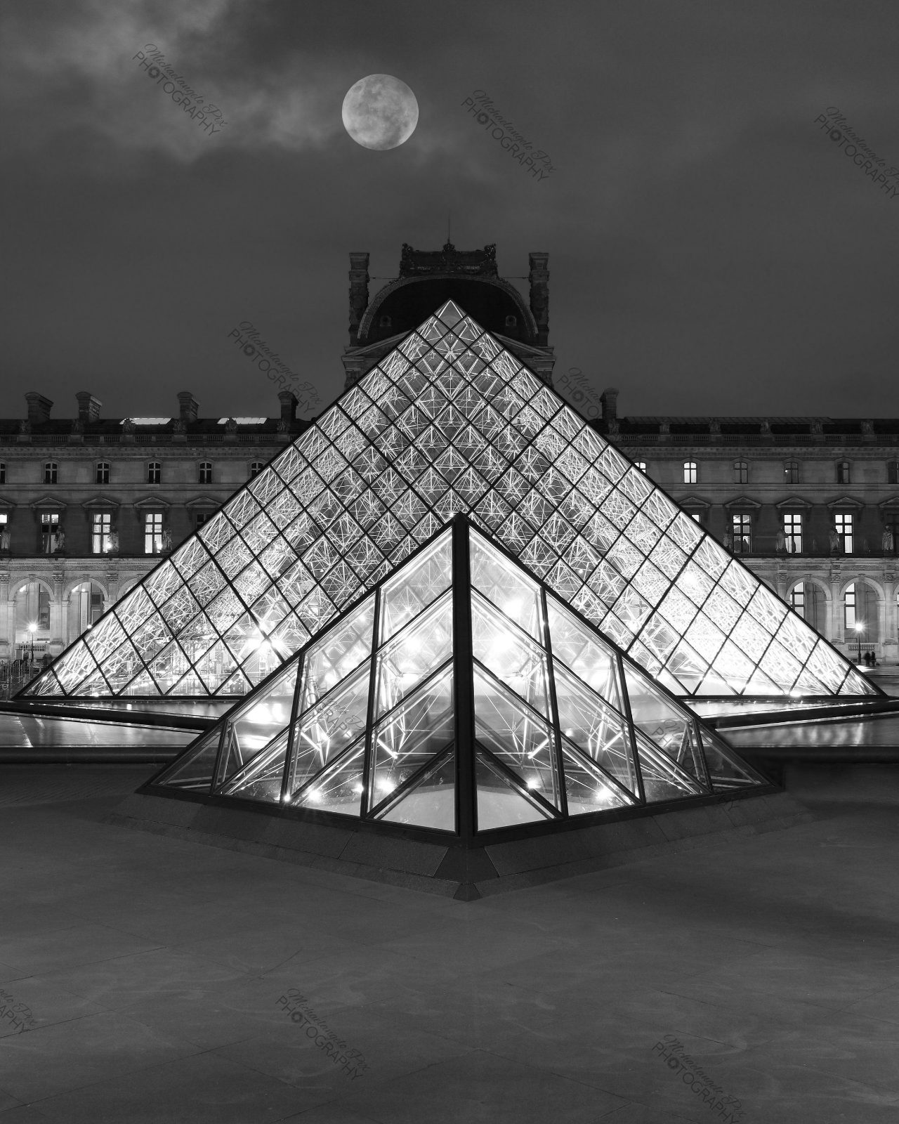 Louvre Pyramid under a full moon