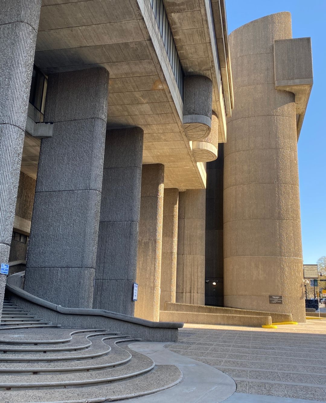 Round concrete towers over curved steps