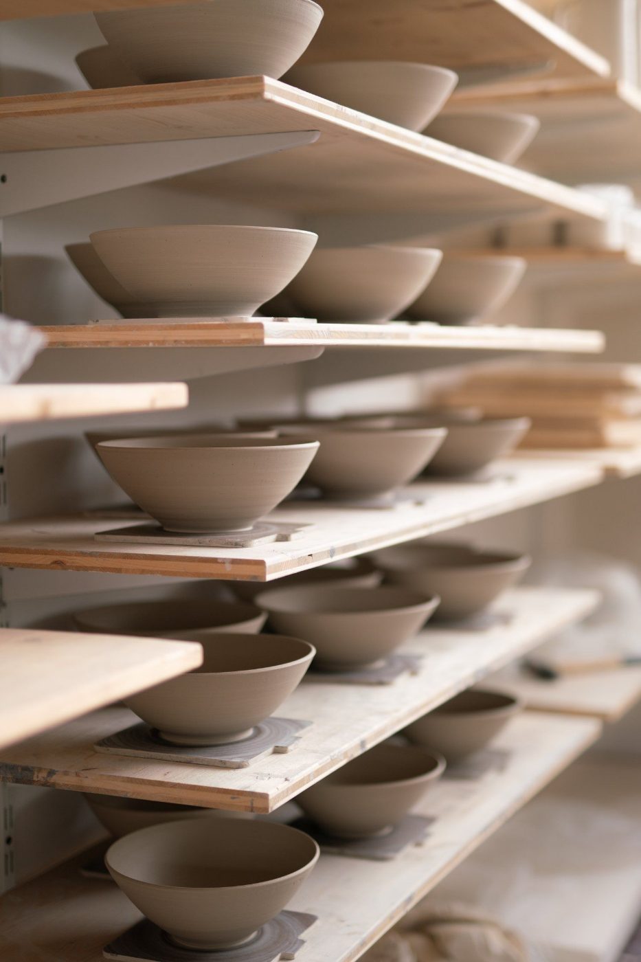 Bisque-fired bowls on ware boards