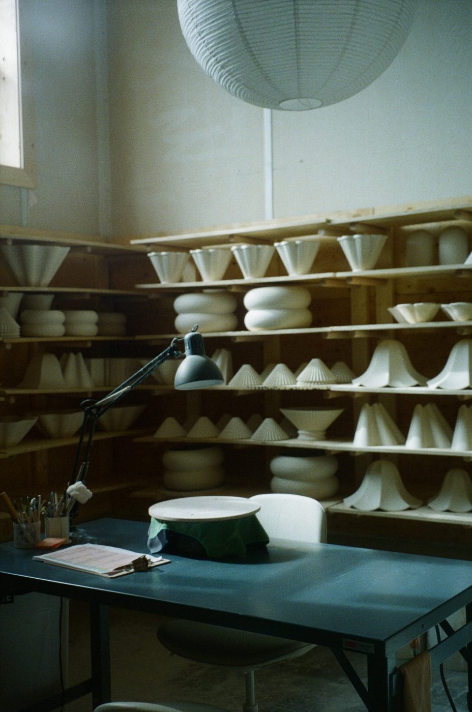 Room of bisque-fired forms on shelves