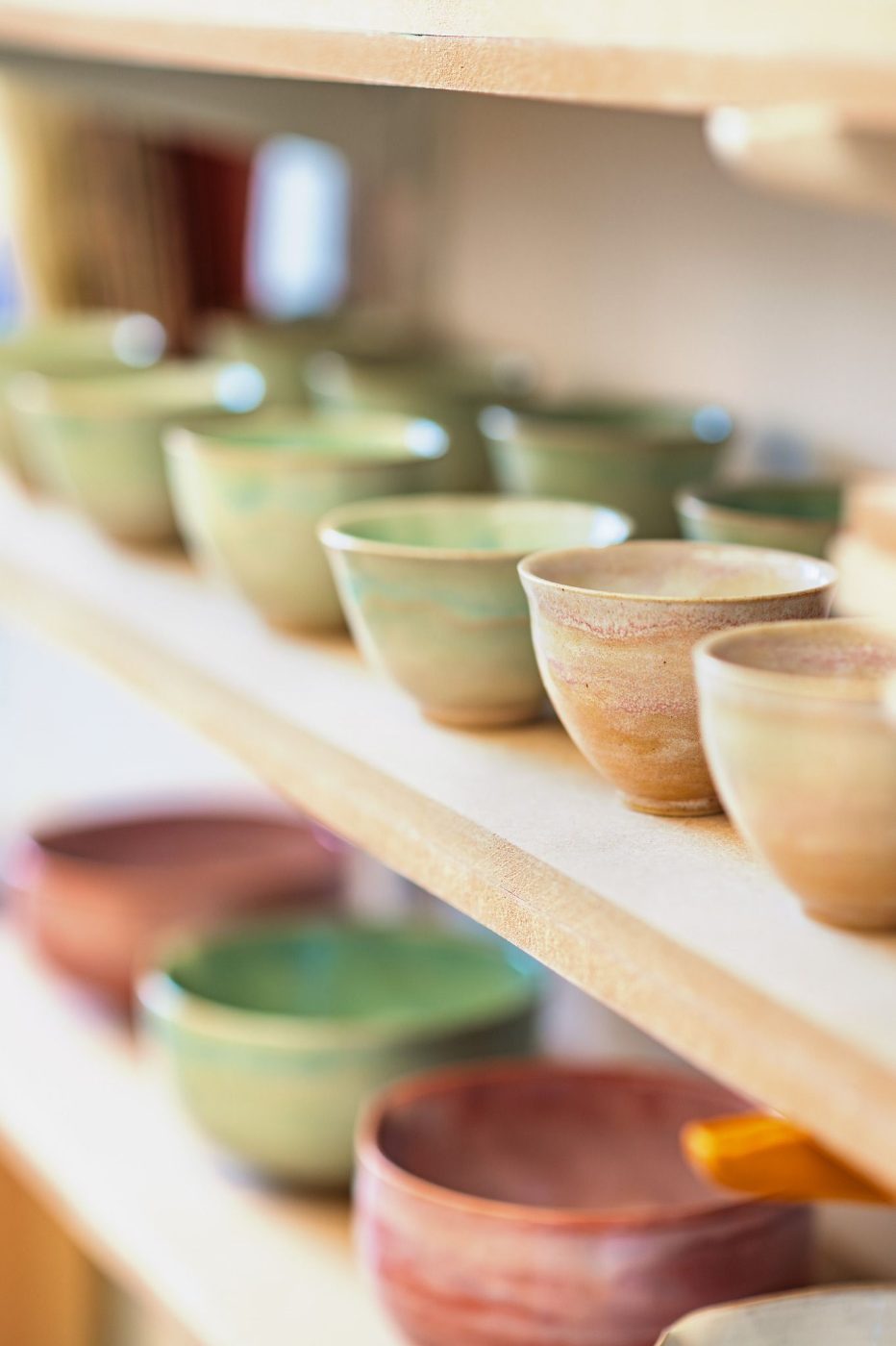 Glazed cups on a shelf