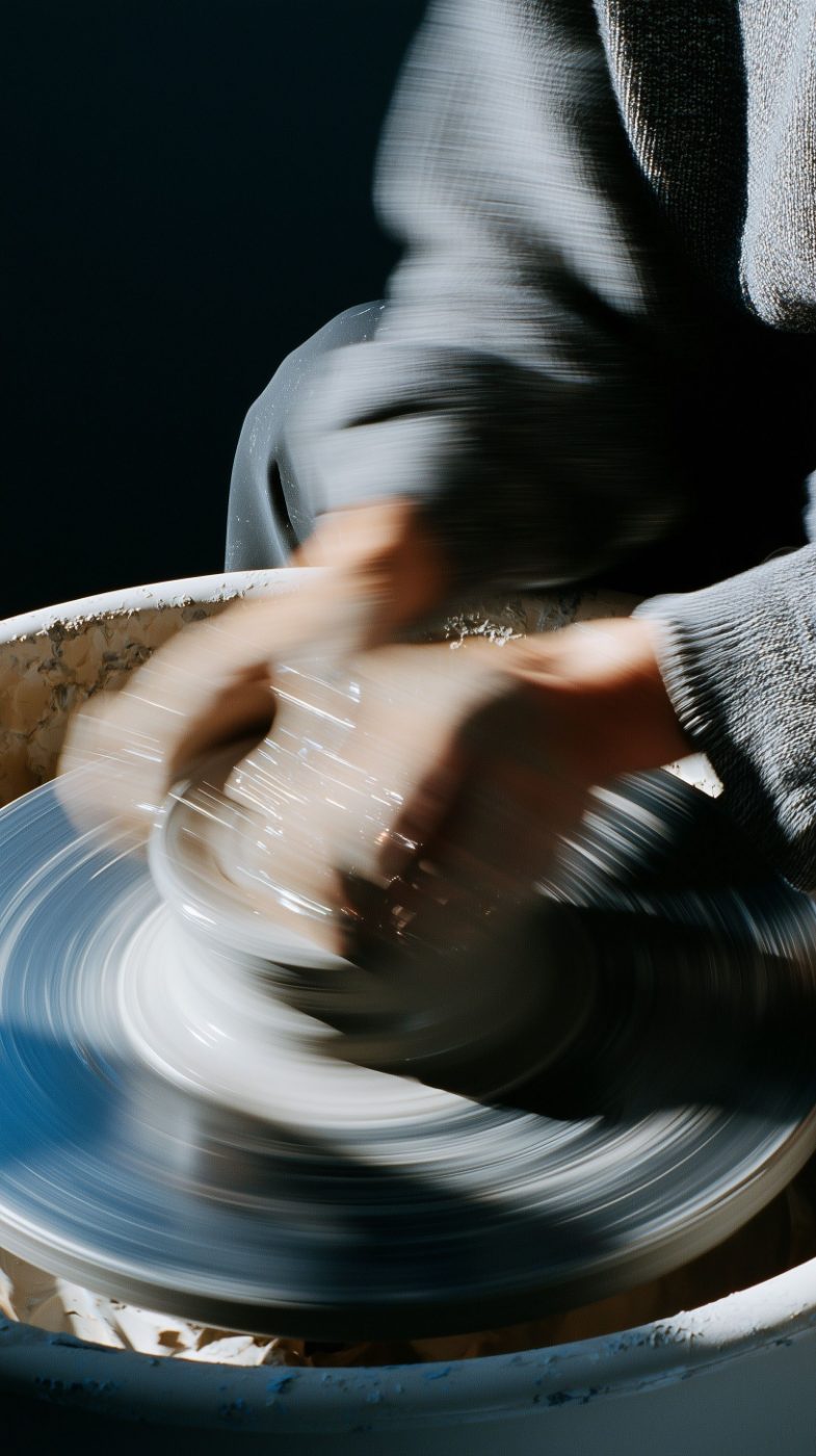 Hands throwing on a spinning wheel