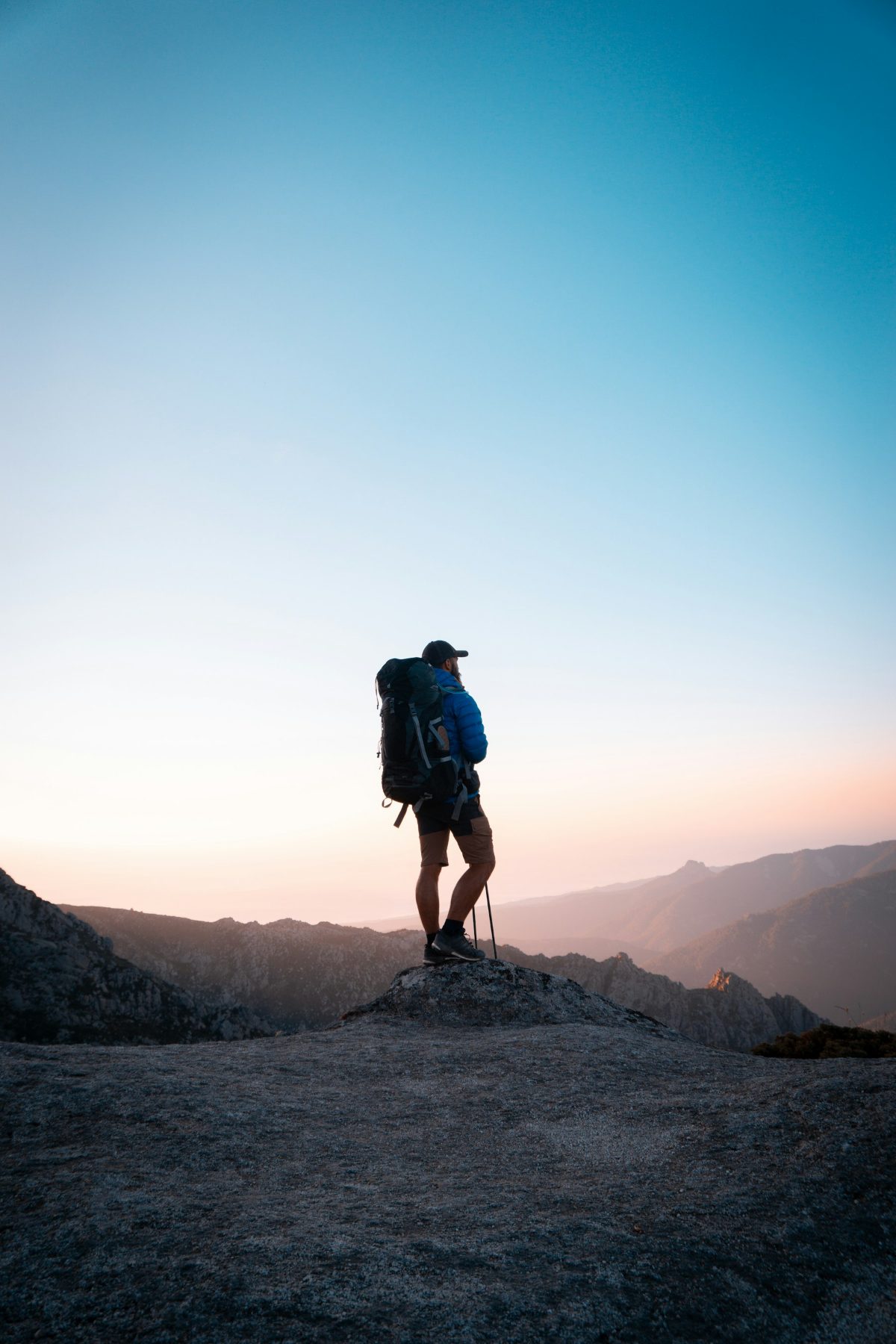 Hiker standing on a ridge at dawn