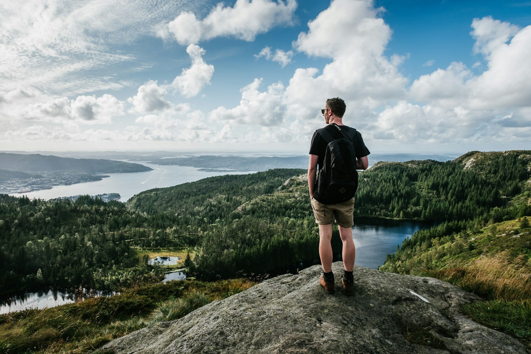 Hiker above a lake and forest