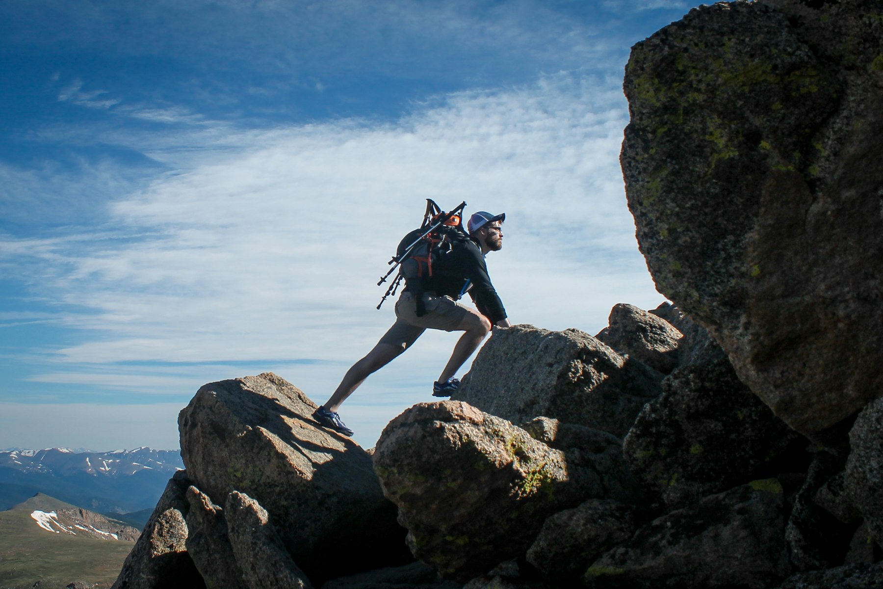 Climber stepping between boulders