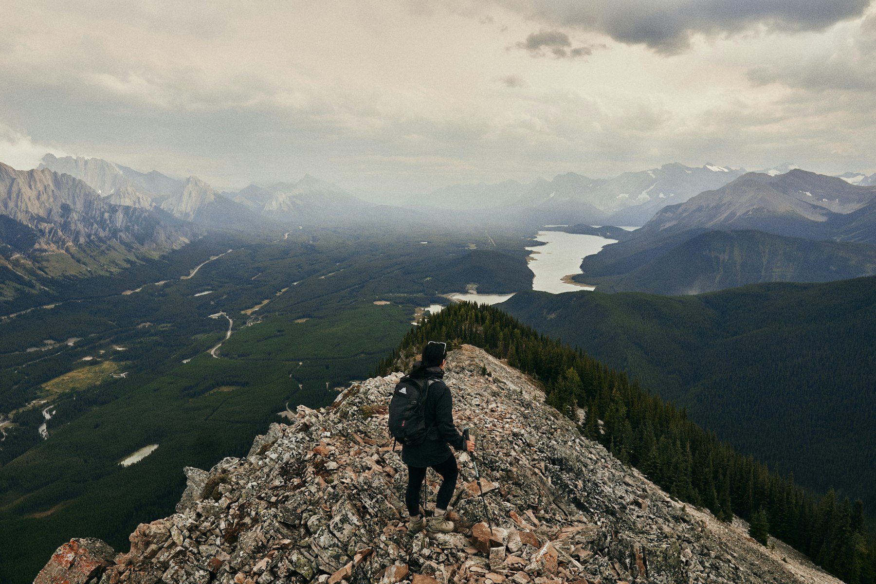 Hiker walking a rocky ridge above a valley