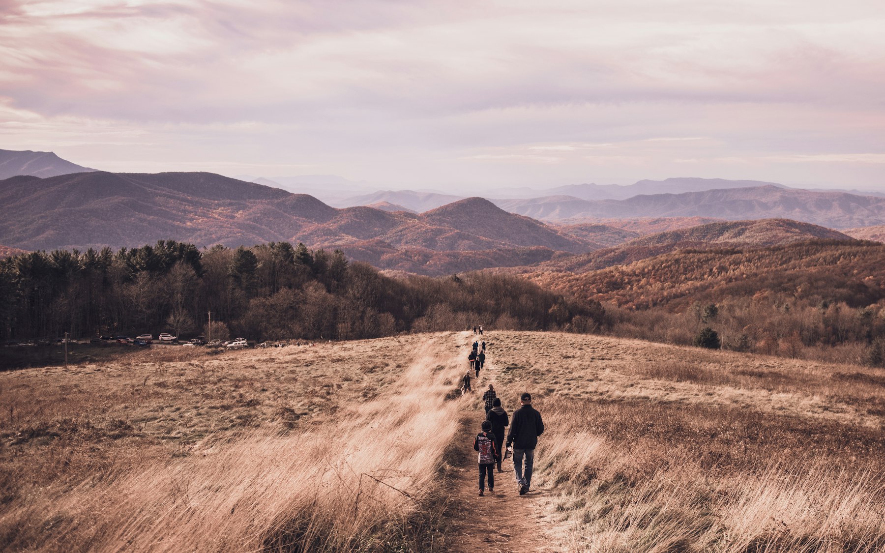 Walkers on a dry grass ridge