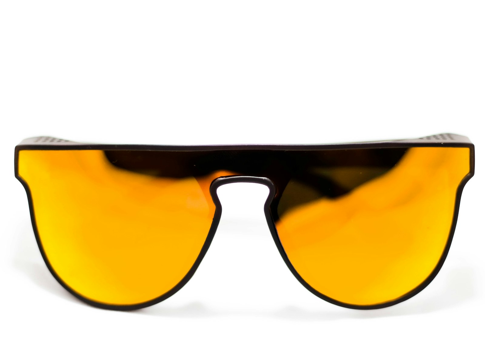 Orange lens sunglasses on a sand-coloured background