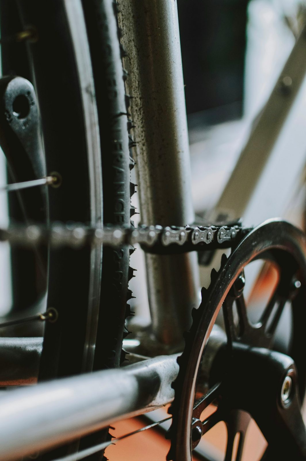 Chainring and chain on a steel road frame, close up in a workshop