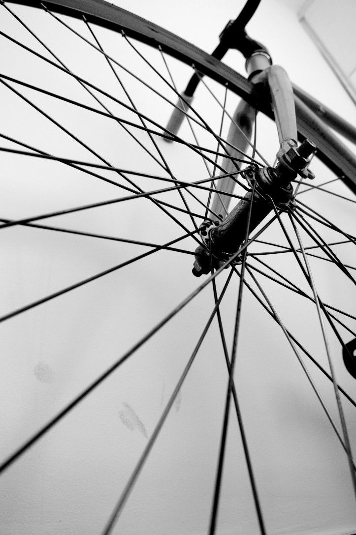 Black and white front wheel and fork seen from below, spokes fanning out from the hub
