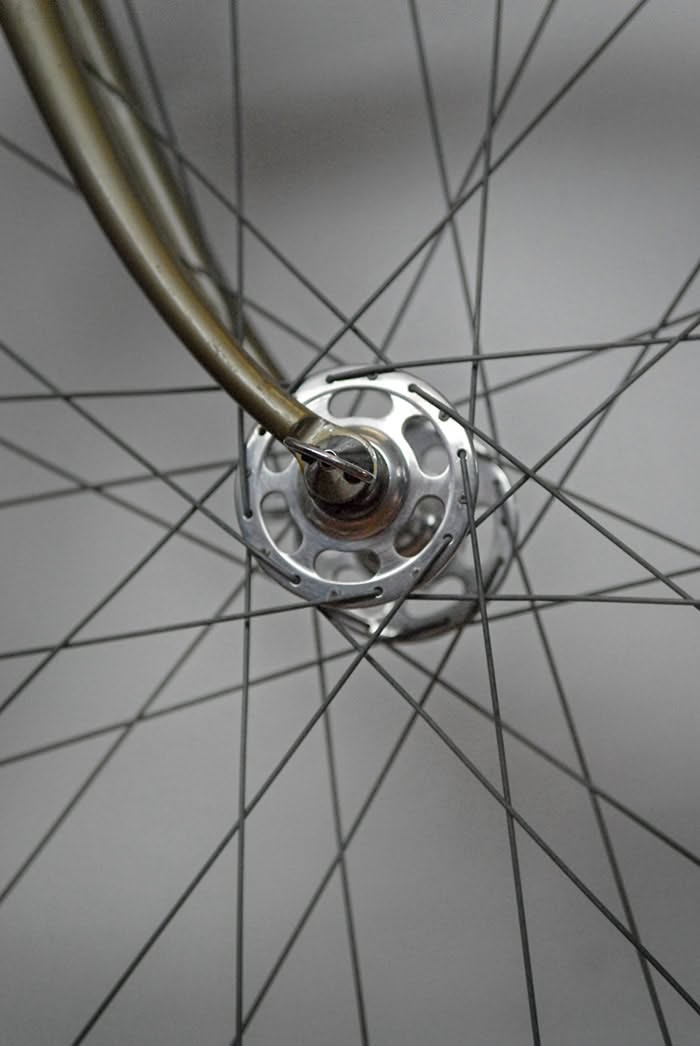 Close-up of a drilled front hub with crossing spokes