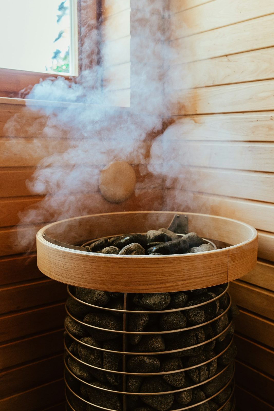 Steam rising from a round sauna heater