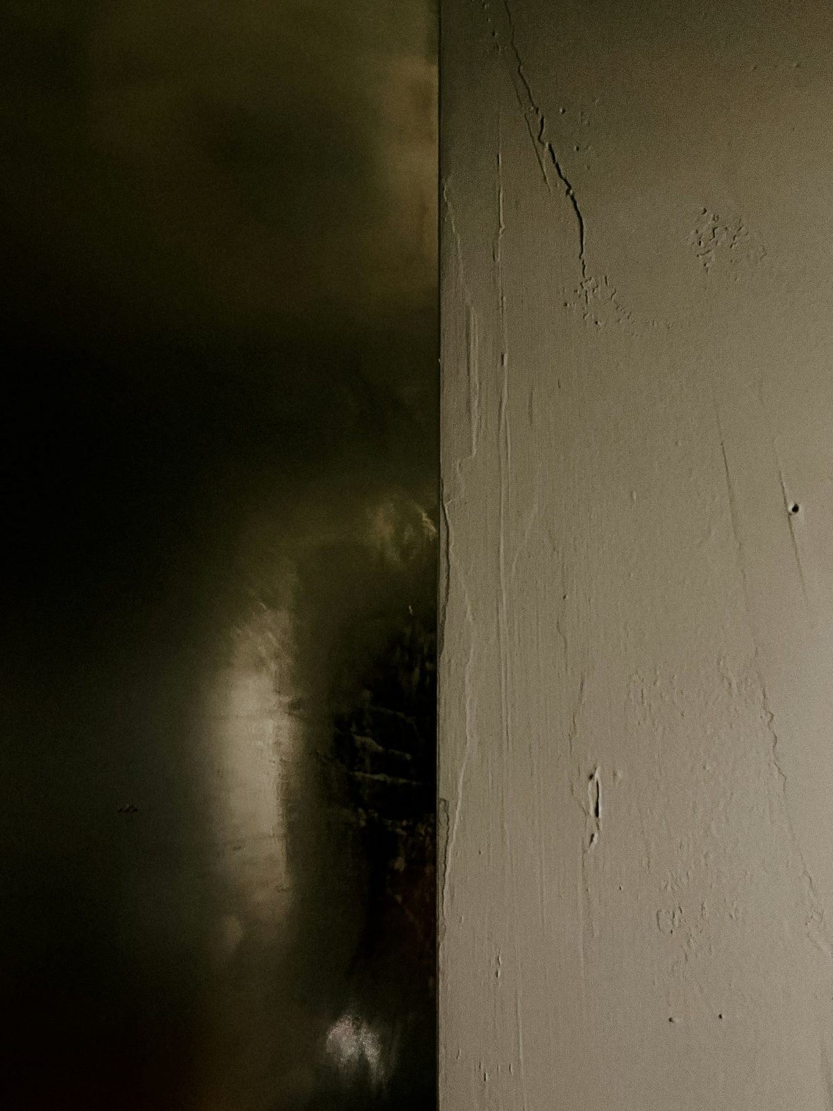 Soot-dark wall beside the smoke sauna door