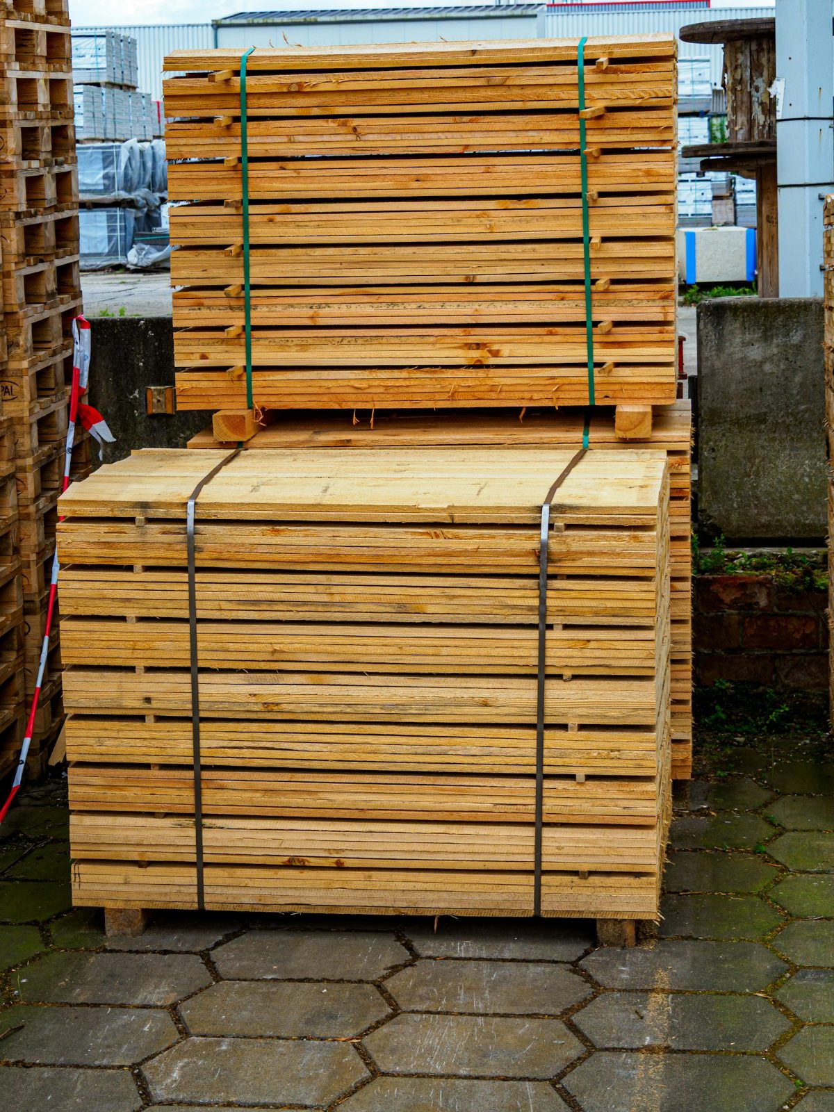 A timber yard with racks of sawn boards under a roof