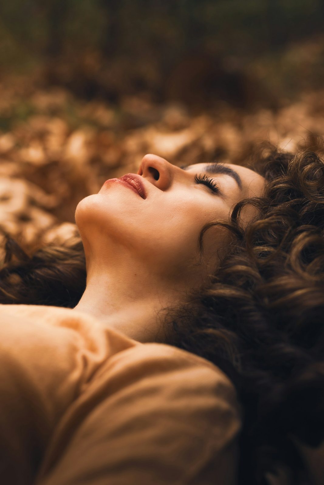 Woman lying down, warm light on skin